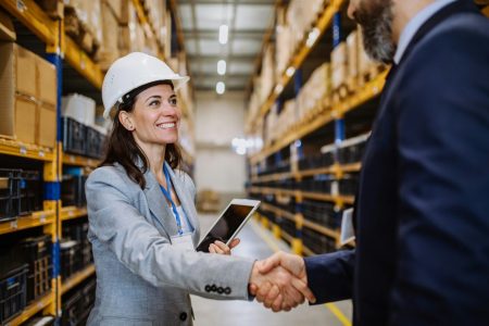 managers-in-suits-shaking-hands-in-warehouse-